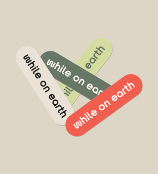 while on earth™ sticker